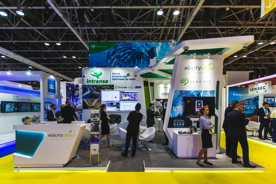 Agility exhibition stand seen from the aisle, with visitors at the counter