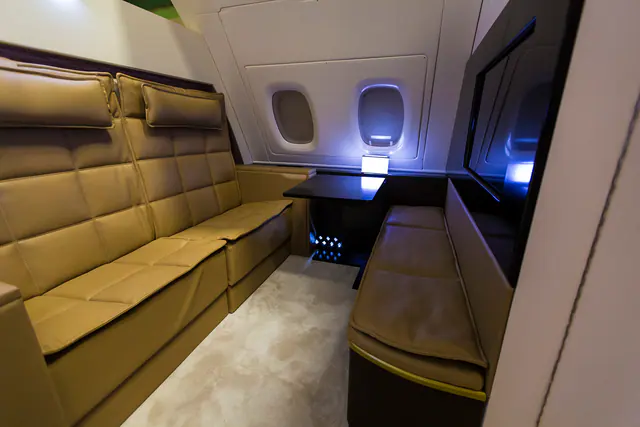 Upholstered cabin seating in tan leather with stitched panels