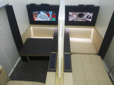 Upholstered seating built into a cream panelled interior
