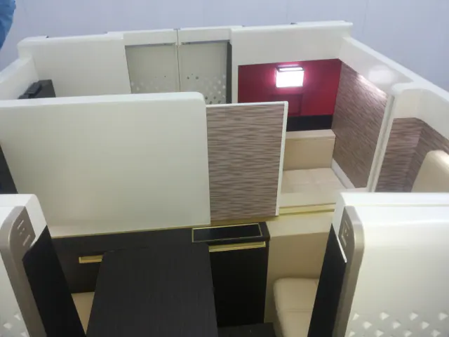 Fitted interior with cream panelled walls and built-in seating