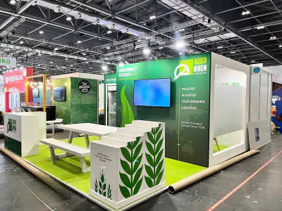 Green and white exhibition stand with a screen and counter