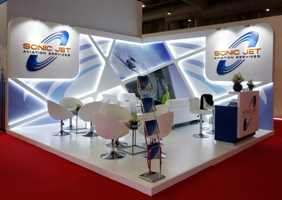 Sonic Jet Aviation Services stand with angled white panels, blue graphics and edge lighting
