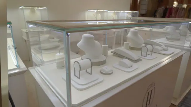 Tall glass display case on a white plinth