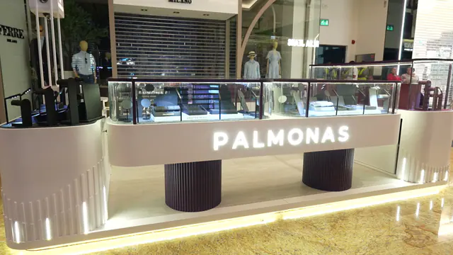 Side view of the kiosk showing the fluted plinths and lit base